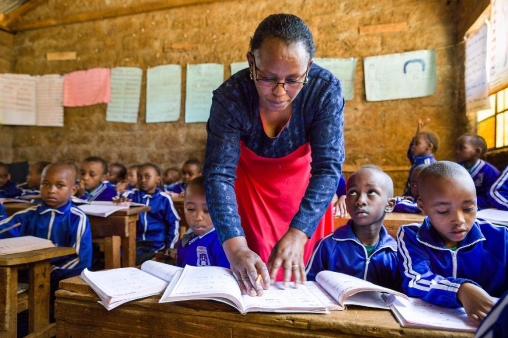 A teacher and her students in class Kenya 1