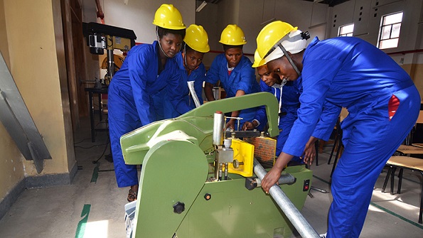 Photo of students operating a machine as part technical education